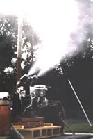Fogging machine spraying insecticide in an open area 