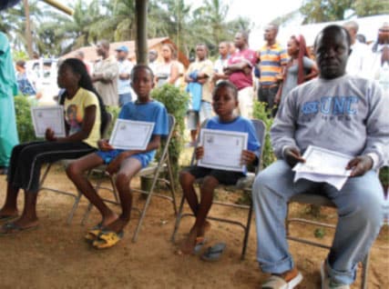 Ebola survivors, three orphans and their uncle, receiving Certificate of Medical Clearance as part of the Firestone Ebola Survivor Reintegration Program - Firestone District, Liberia, 2014
