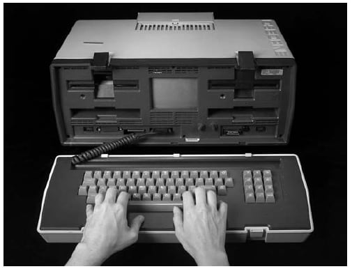 The figure is a photo of a 'Luggable' Osborne computer in 1982.