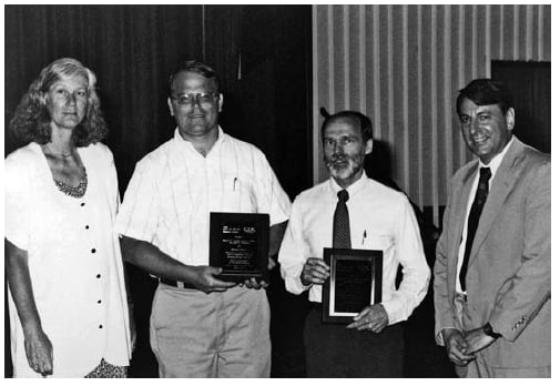 The figure is a photo at CDC's Statistical Achievement Ceremony in 1993. Pictured are winners of the Award for Statistical Methods to Investigation: Clair V. Broome (presenter), James Pirkle, Samuel Caudill, and Mitchell Gail.f