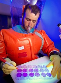 CDC scientist, Zach Braden, in BSL4 suit, 2013