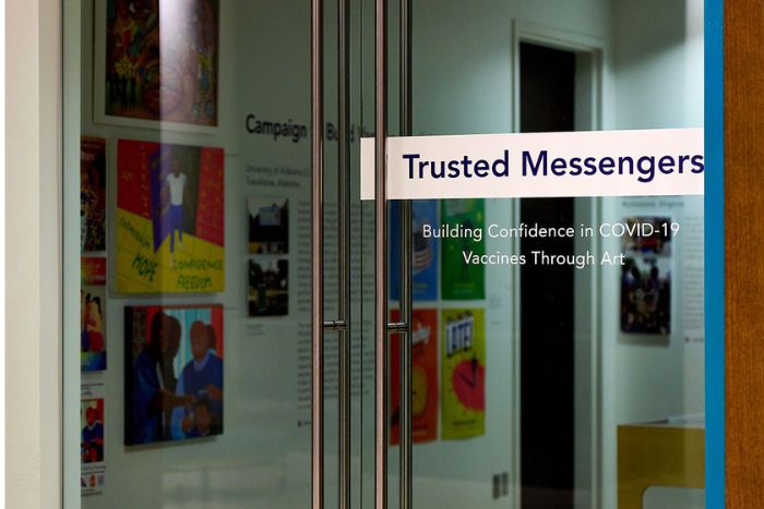 Glass door with Trusted Messengers sign