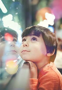 a boy looking at glass