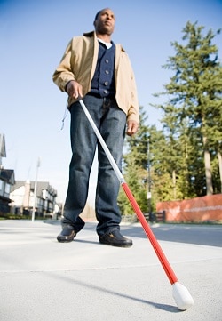 Blind man using walking stick