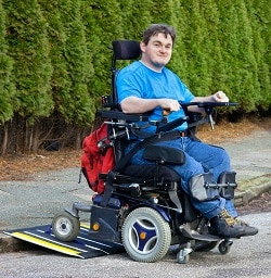Disabled young man in an electric wheelchair