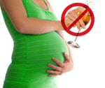 Pregnant woman holding wine glass with the glass crossed out