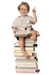 Child sitting on stack of articles