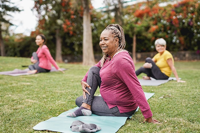 Women doing yoga exercise outdoors