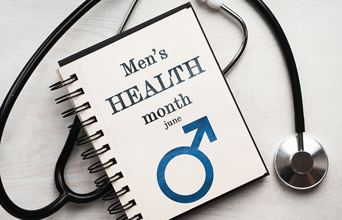 Mens Health Month written on note pad with stethoscope in the background - concept image