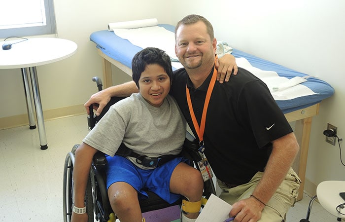 A boy with spina bifida and a health care provider