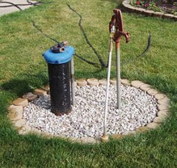 Photo of a common household private well in a yard.