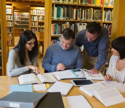 Group of people working together in a library