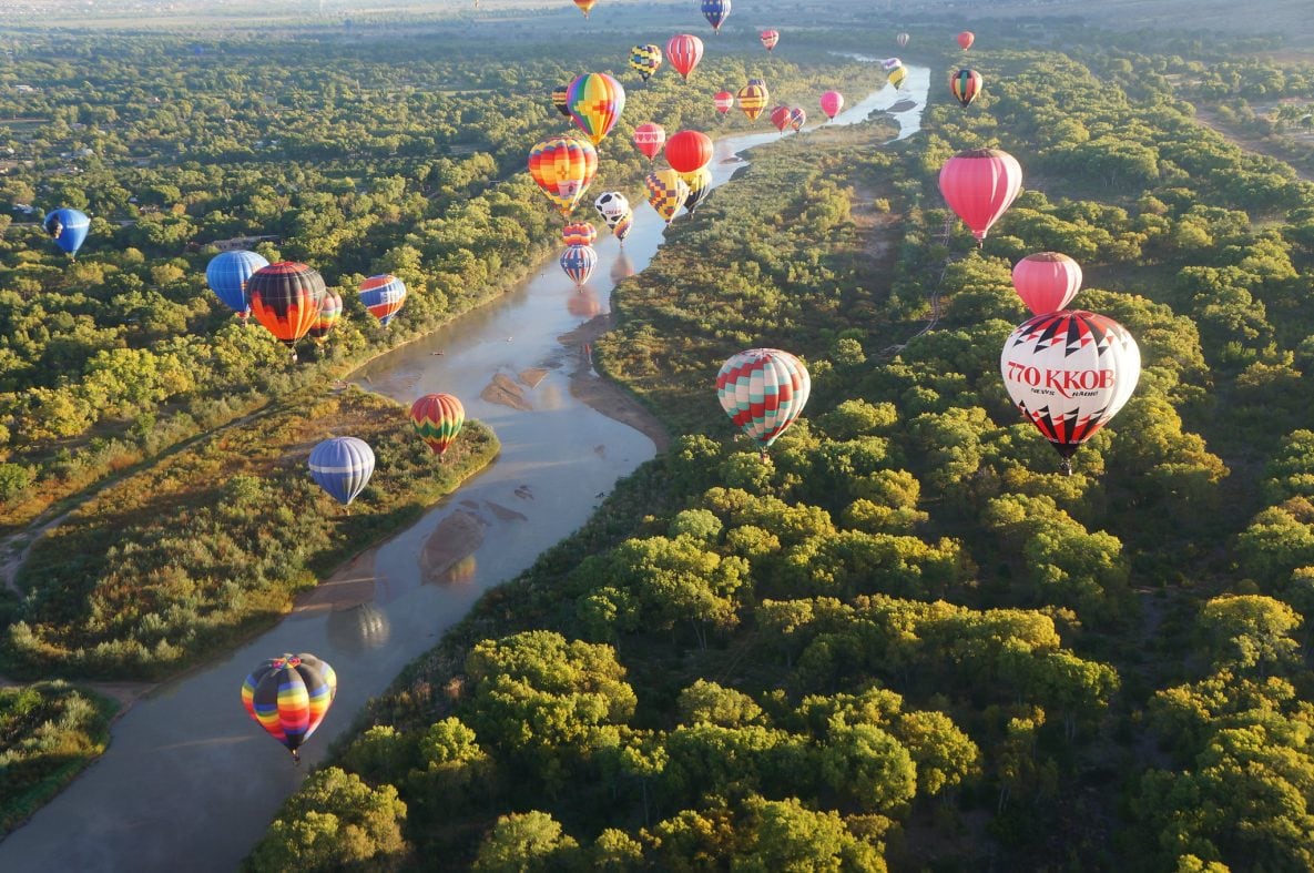Hot air balloons floating above the Rio Grande