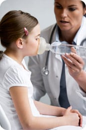 Female physician treating young girl's asthma