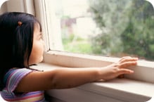 Young girl looking out of window