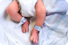 Newborn baby's feet with hospital bracelet