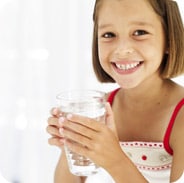 Young girl holding glass of water