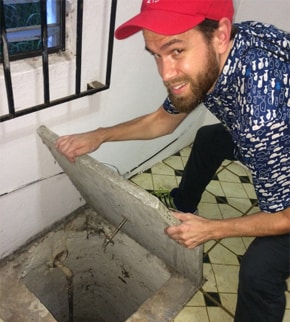 man inspecting a cistern