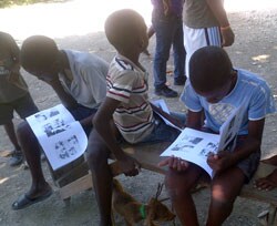 Children read an informational comic book that teaches lessons on rabies. 