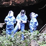 scientist near a cave in Uganda