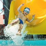 thumbnail image - boy falling off end of yellow water slide