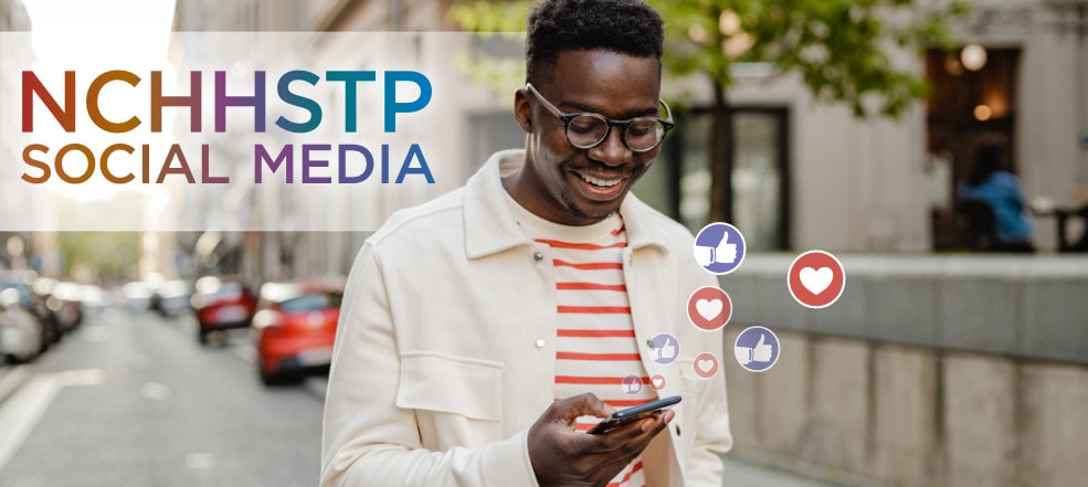 NCHHSTP Social Media - A man in an urban outdoor setting looking at his mobile device with thumbs-up and heart emoji icons floating nearby