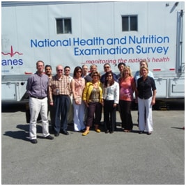 Informatics Branch staff in front of the Mobile Examination Center
