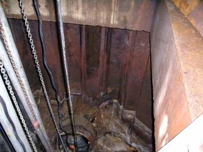Pipe and plug at base of manhole