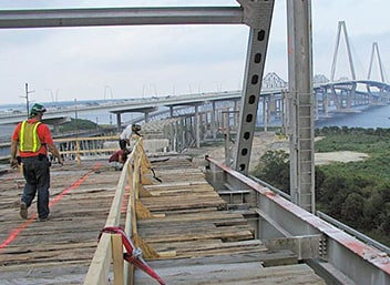 Bridge deck construction with wooden catch platforms.