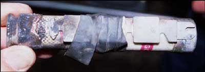 A melted fuse was repaired by taping a renewable fuse link on the outside.