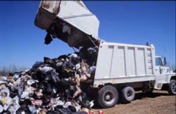 Photo 5. Internal plate pushing compacted garbage out of the truck.