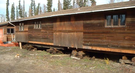 Figure 1 Raised building supported by beams on wood blocks or cross supports