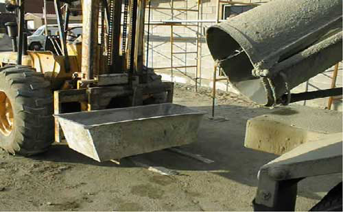 Picture 6.  Forklift with cement bucket on forks and rear of cement truck.