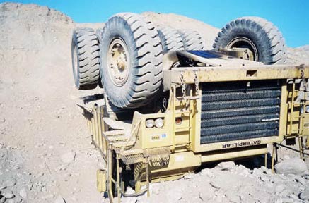 View of the truck as it came to rest after tumbling over the embankment.