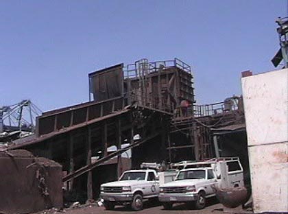 Exhibit #2. Side view of the mill showing the conveyor rail and hopper.