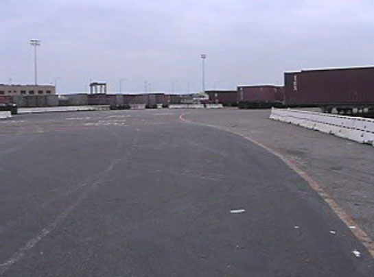 Exhibit 3. A picture of the incident scene looking west. The forklift came from the area to the right of the picture.