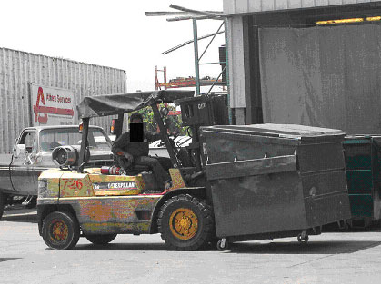 Exhibit 1. Picture of a forklift transporting a trash 
      bin similar to the one involved in this incident.