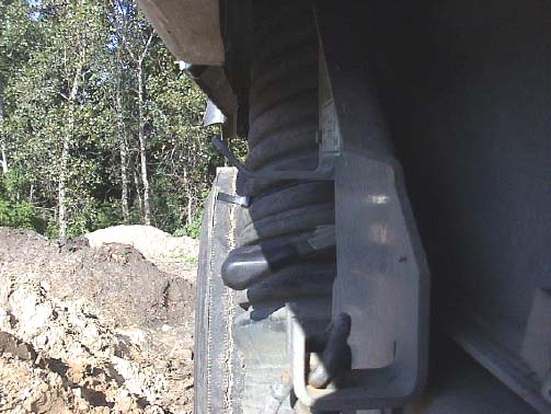 Figure 3b. End view of hopper levers and safety plate – NOTE: plate extends to ends of levers.