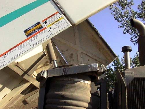 Figure 4b. Close up of space between side of hopper and top of suction hose.