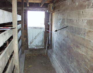 Photo #1.  Looking south towards vet room door indicated by arrow.