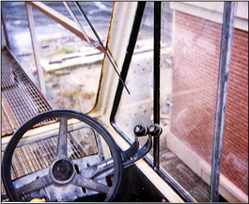 Photo 2: View from operator’s cab overlooking straddled load (brick wall)