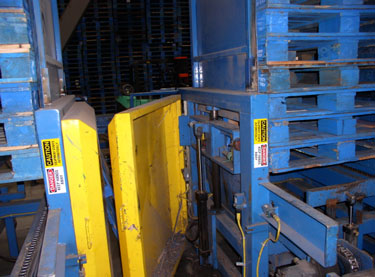 Exhibit #4. View of the hydraulic mechanism and electronic eyes used in the stacking process.
