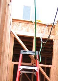 Photo 3. Workers at this site were using the top step of the stepladder to step from the ladder onto the door header (actually the landing for future stairs) and then finally onto the second floor.