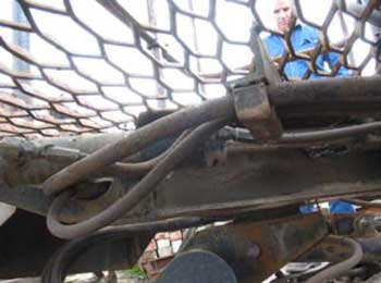 Figure 4: Exposed hydraulic lines under grating of work platform.