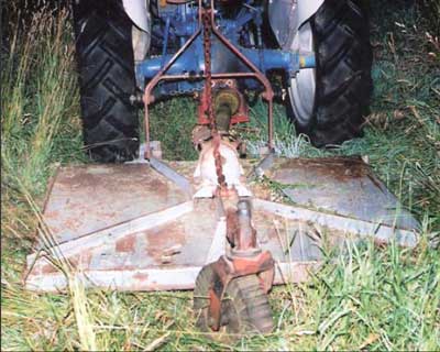 rotary cutter attached to the tractor&rsquo;s three-point hitch