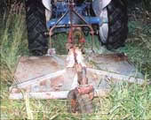 rotary cutter attached to the tractor&rsquo;s three-point hitch