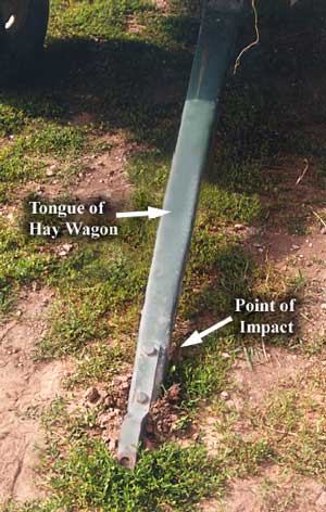 Photo 2 – Front view of the hay wagon, showing the tongue, which had bulldozed into the ground as the wagon rolled forward.