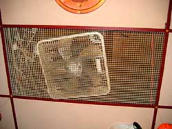 Figure 3. Fan laying on ceiling panel in bar area.