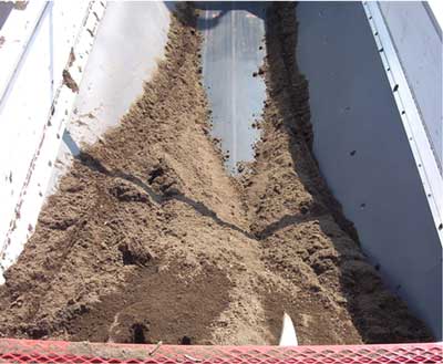 Inside the hopper of a similar pneumatic blower truck, showing the location of the augurs and agitators.