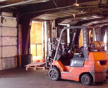 Figure 1. Forklift driven by decedent on dock